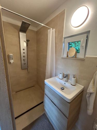 a bathroom with a sink and a shower at Prázdninový domeček in Heřmanice