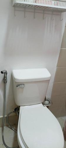 a bathroom with a white toilet in a room at Rooms in Bloom in Tarlac