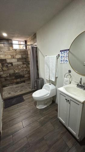 a bathroom with a toilet and a sink at Hotel Villas Mariposas in Atlixco