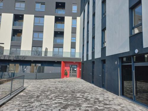a building with a red door in front of it at Apartman Symbol in Tuzla