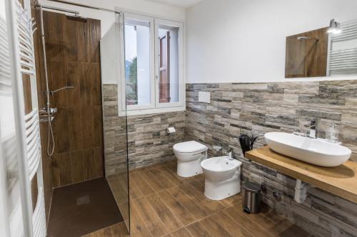a bathroom with a sink and a toilet and a shower at CaMagnolia Apartment in Montegrotto Terme