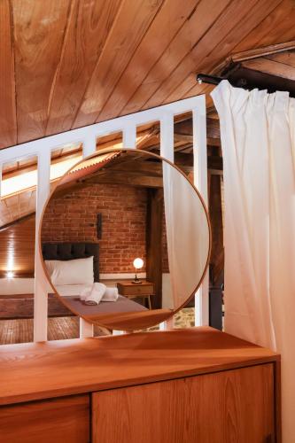 a bedroom with a circular mirror on a table at Elia City House in Kavála