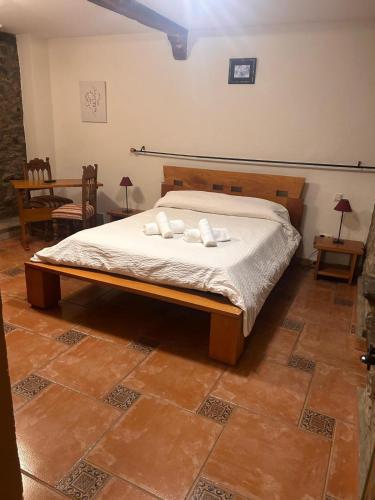 a bedroom with a bed with two pillows on it at Casa Rural Villacampa (Nocito) in Nocito