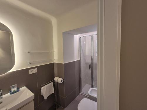 a bathroom with a toilet and a sink and a shower at Rezzano 12 in Bonassola