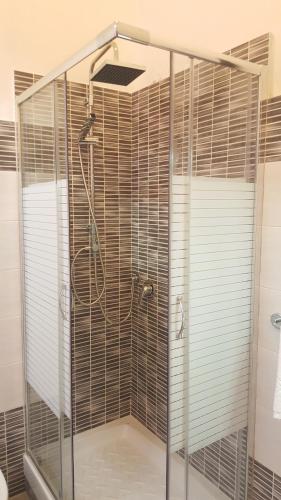 a shower with a glass enclosure in a bathroom at Royal Suite in Genoa