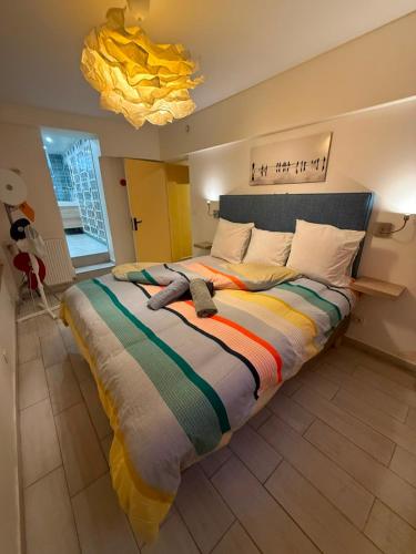 a bedroom with a large bed with a colorful blanket at Welcome in Issy-les-Moulineaux