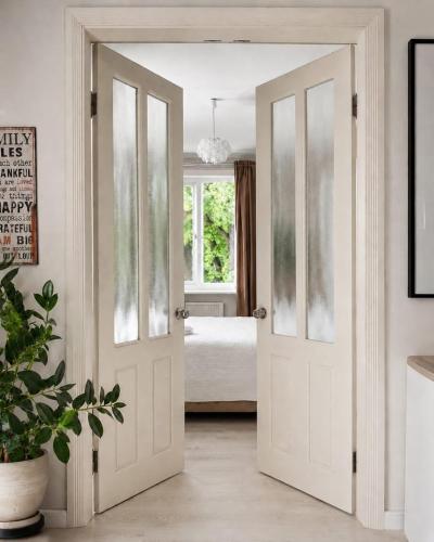 an open door in a room with a bedroom at Stylish air-conditioned Klaipeda Flat, Near Dane River in Klaipėda