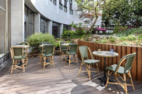 a row of chairs and tables on a patio at Le Méridien Paris Arc De Triomphe in Paris