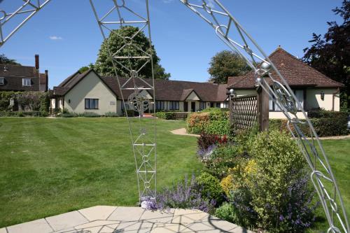 a large metal structure in front of a house at Best Western Priory Hotel in Bury Saint Edmunds