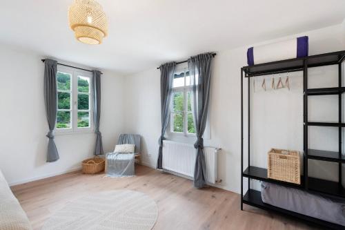 a living room with white walls and wooden floors at Ferienhaus Bühlertal mit 3 Fewos in Bühlertal