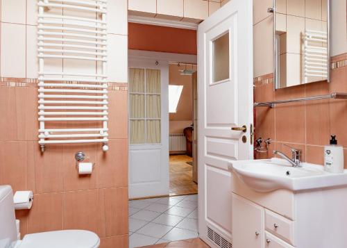 a bathroom with a sink and a toilet at MM Pokoje in Dziwnówek