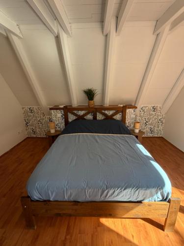 a bed in the middle of a room at Chalet 6 à 8 personnes in Drulhe