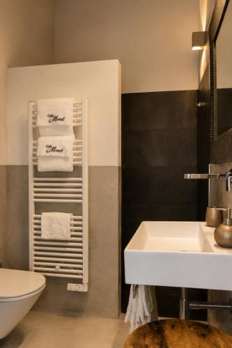 a bathroom with a sink and a towel rack at Villa Monet in Castiglione di Ravenna