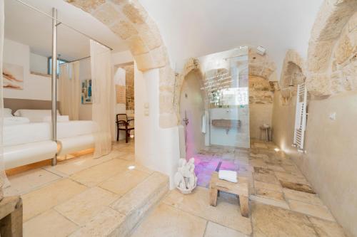 a bathroom with a shower and a sink in a room at Antico Mondo Rooms & Suites in Polignano a Mare