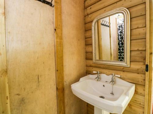 a bathroom with a sink and a mirror at The Moroccan Bell Tent in Newbury
