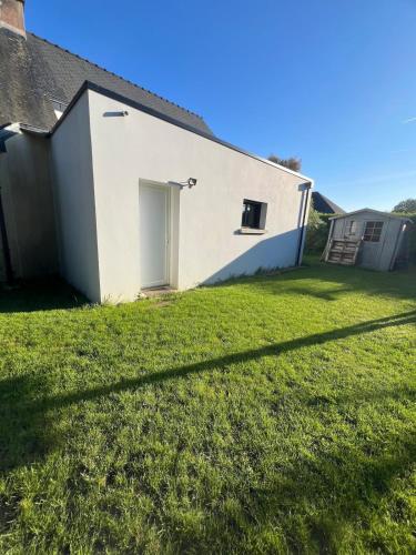 a house with a lawn in front of it at Studio indépendant à notre maison in Concarneau