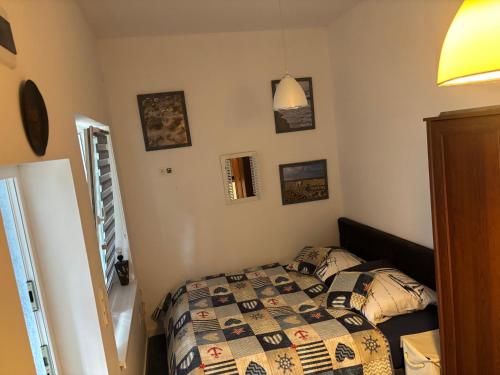 a bedroom with a bed with a quilt on it at Żagiel 3 in Pobierowo