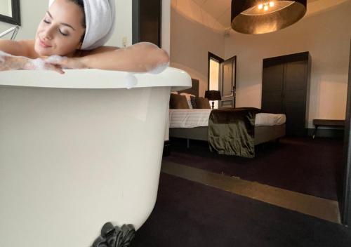 a woman in a bath tub in a hotel room at B in Antwerp in Antwerp
