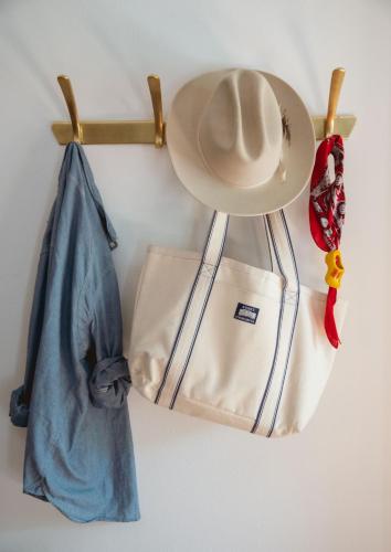 a hat and two bags hanging on a wall at Locanda Hemingway in Bassano del Grappa
