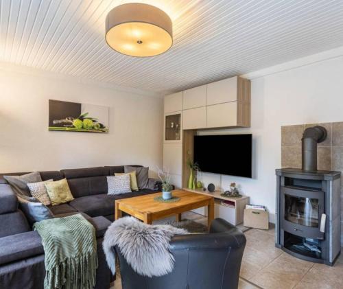 a living room with a couch and a wood stove at diemelseeholiday romantisches Ferienhaus im Sauerland Nähe Willingen Winterberg in Diemelsee