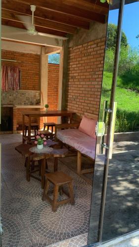 an outdoor patio with a bench and a table at Villa Virgen De La Gracia in Tobatí