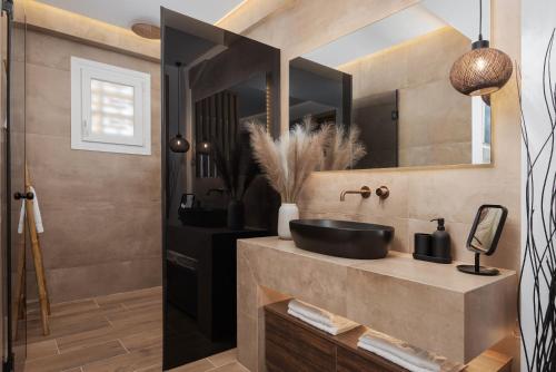 a bathroom with a sink and a mirror at Vouliagmeni Olivomare Suite in Athens