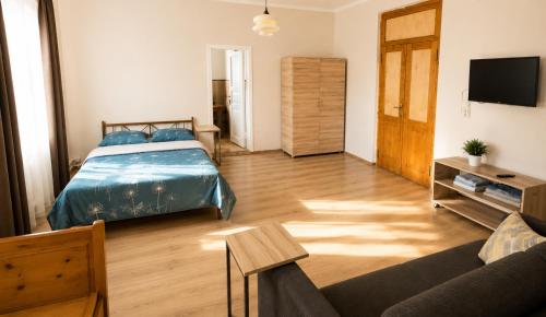 a bedroom with a bed and a living room with a couch at Tuz House R7 in Bakuriani