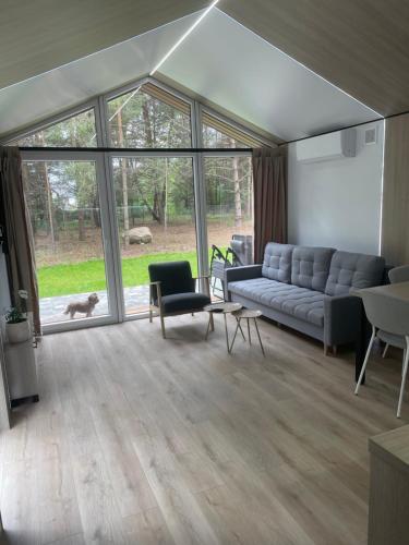 a living room with a couch and a table at Domek pod brzozami in Waszki