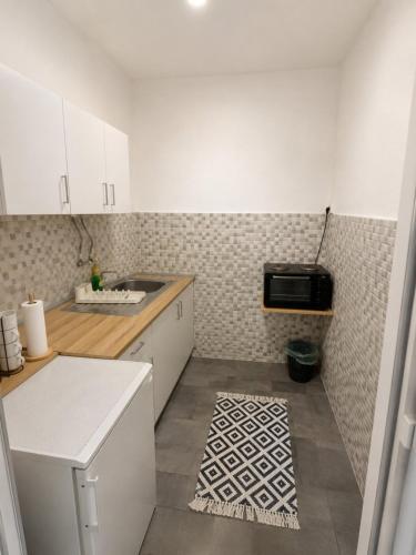 a small kitchen with a sink and a microwave at Villa Jovan Gevgelija in Gevgelija