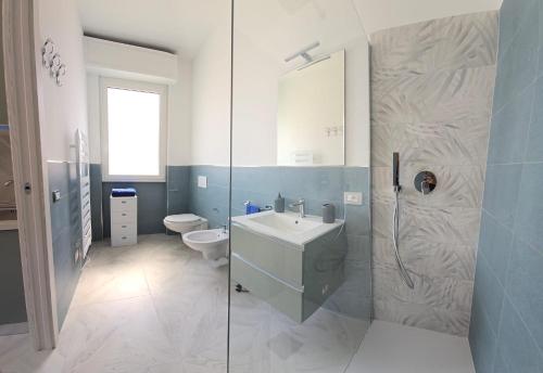 a bathroom with a sink and a toilet and a shower at Casa di Bea 2 in Ventimiglia