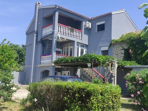 a house with a car parked in front of it at Lydia in Vrsi