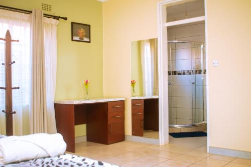 a bathroom with a sink and a shower at The Cottage in Lilongwe