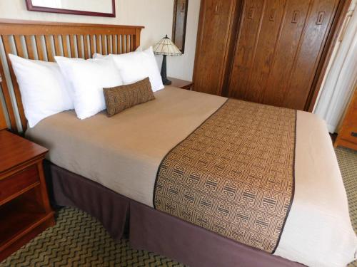 a bedroom with a large bed with white pillows at Capitola Venetian Vacation Rentals in Capitola