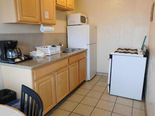a kitchen with a white refrigerator and a sink at Capitola Venetian Vacation Rentals in Capitola
