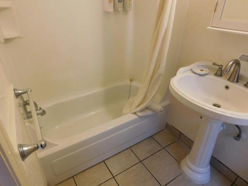a bathroom with a sink and a tub and a toilet at Capitola Venetian Vacation Rentals in Capitola