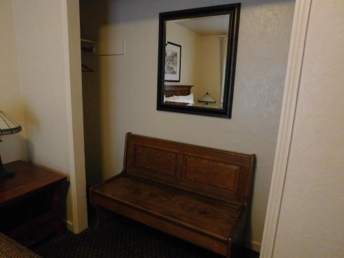a mirror on a wall next to a wooden bench at Capitola Venetian Vacation Rentals in Capitola