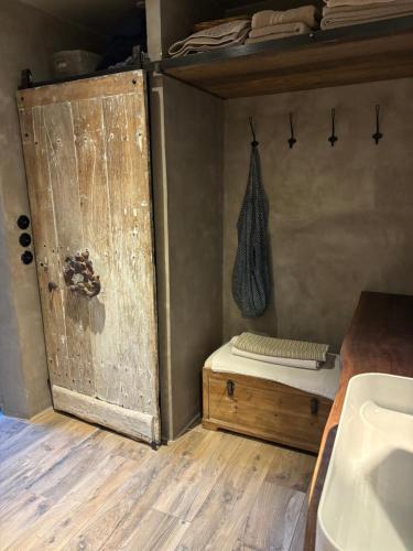 a bathroom with a bed and a wooden floor at La Vieille Demeure in Barbizon