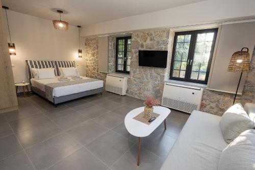 a living room with a bed and a couch at Argolis Rodies Homes in Kilada