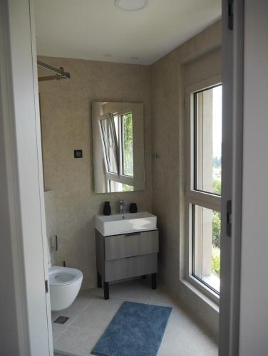 a bathroom with a sink and a mirror at Apartment Marta Tivat in Tivat