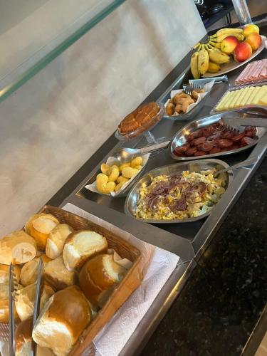 a buffet line with different types of bread and other foods at Hotel Familiar in Salinas