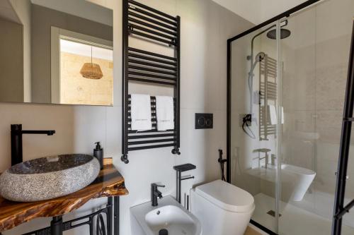 a bathroom with a sink and a toilet and a shower at Domus Sagari in Presicce
