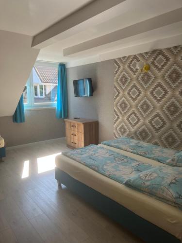 a bedroom with a bed and a window with blue curtains at Baracuda in Dębki