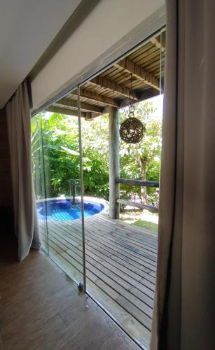 a sliding glass door with a view of a swimming pool at Villas Supreme Apartamentos in Maceió