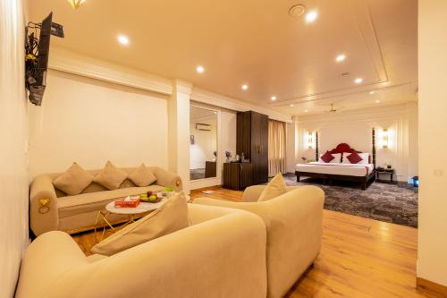 a living room with two couches and a bed at The Saga Hotel Green Park in New Delhi