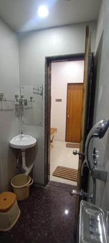 a bathroom with a sink and a toilet and a shower at Savanna Farm in Nagpur