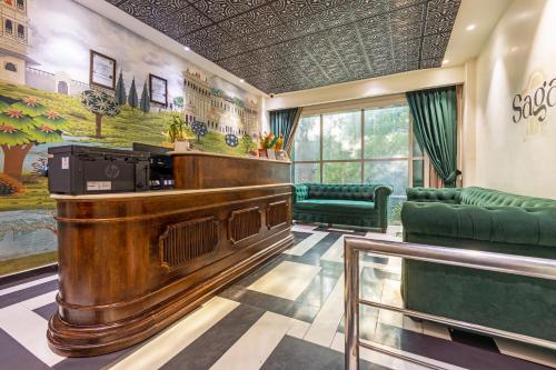 a bar in a waiting room with a piano at The Saga Hotel Green Park in New Delhi