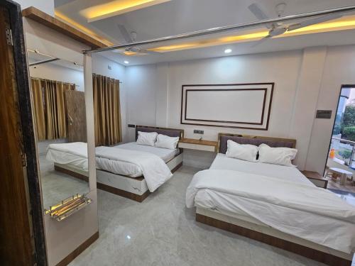 a hotel room with two beds and a window at Savanna Farm in Nagpur