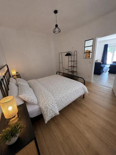 a bedroom with a bed and a living room at The Nook, Lourinha in Lourinhã
