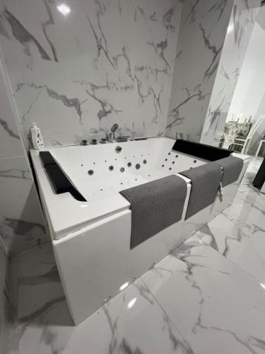 a bathroom with a bathtub with a towel on it at Gandía Jacuzzi Suites in Gandía
