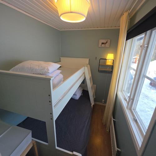 a bedroom with a bunk bed with a window at Örnen' in Undenäs